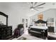 Elegantly furnished main bedroom with a stylish bed, walkout to lanai, and luxury massage chair at 5458 Zamia Dr, Brooksville, FL 34604