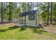 A charming backyard outbuilding featuring wooden doors and a stone base at 5458 Zamia Dr, Brooksville, FL 34604