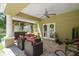 Comfortable outdoor covered patio with brick floors and stylish seating area for relaxing and entertaining at 5458 Zamia Dr, Brooksville, FL 34604