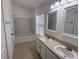 Clean bathroom with a double vanity, bath, shower, and tile flooring, creating a functional space at 5527 Kinglethill Dr, Lithia, FL 33547