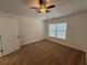 Simple bedroom with neutral carpeting, a ceiling fan, and a window allowing ample natural light at 5527 Kinglethill Dr, Lithia, FL 33547