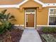 Home's exterior featuring a brown front door and well-manicured landscaping at 5527 Kinglethill Dr, Lithia, FL 33547