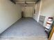 Garage featuring an epoxy floor and room for storage at 5527 Kinglethill Dr, Lithia, FL 33547