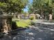 Community's gated entrance with stone pillars, landscaping, and a keypad for secure access at 5527 Kinglethill Dr, Lithia, FL 33547