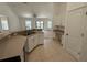 Bright kitchen featuring ample countertop space, white cabinets, and an open view into the living area at 5527 Kinglethill Dr, Lithia, FL 33547