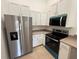 A kitchen featuring stainless steel appliances, white cabinets, and neutral countertops at 5527 Kinglethill Dr, Lithia, FL 33547