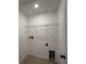 Laundry room with white walls, tile floor, and metal shelving at 5527 Kinglethill Dr, Lithia, FL 33547