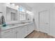 Elegant bathroom with double sinks, granite countertops, and ample cabinet space at 5539 Silver Sun Dr, Apollo Beach, FL 33572
