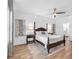 Cozy bedroom featuring a four-poster bed, ceiling fan, and soothing wall art at 5539 Silver Sun Dr, Apollo Beach, FL 33572