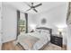 Bright bedroom featuring a ceiling fan, gray accent furniture, and a view to the outdoors at 5539 Silver Sun Dr, Apollo Beach, FL 33572