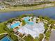 Stunning aerial view of a community clubhouse, pool, and lake, offering a luxury lifestyle at 5539 Silver Sun Dr, Apollo Beach, FL 33572