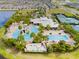 Aerial view of the community pool and clubhouse featuring a fun water slide and ample seating at 5539 Silver Sun Dr, Apollo Beach, FL 33572