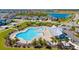 Aerial view of lagoon-style community pool with lounge chairs and landscaping in a residential neighborhood at 5539 Silver Sun Dr, Apollo Beach, FL 33572