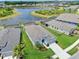 Stunning aerial view of a home with a screened-in pool and peaceful lake as a backyard neighbor at 5539 Silver Sun Dr, Apollo Beach, FL 33572