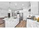 Bright kitchen with white cabinetry, quartz countertops, stainless steel appliances, and pendant lighting at 5539 Silver Sun Dr, Apollo Beach, FL 33572