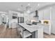 Bright kitchen with white cabinets, quartz countertops, stainless steel appliances, and barstool seating at 5539 Silver Sun Dr, Apollo Beach, FL 33572