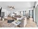 Open-concept living space with a comfortable sofa, modern decor, and open access to the kitchen at 5539 Silver Sun Dr, Apollo Beach, FL 33572