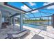 Covered pool with view of the lake, outdoor furniture, and blue sky with fluffy white clouds at 5539 Silver Sun Dr, Apollo Beach, FL 33572
