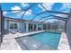 Back of house overlooking the pool with lake view, screened in lanai, and tanning deck at 5539 Silver Sun Dr, Apollo Beach, FL 33572