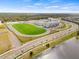 Aerial view of the athletic field and modern building exterior of a school set in a residential area at 5539 Silver Sun Dr, Apollo Beach, FL 33572