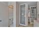 Bathroom with tiled shower features access to additional rooms and a bright exterior window at 5603 Palmetto Rd, New Port Richey, FL 34652