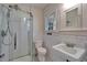 Well-lit bathroom featuring classic subway tile and a glass-enclosed shower at 5603 Palmetto Rd, New Port Richey, FL 34652