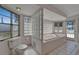 Bright bathroom with a large tub, tiled floors, and glass block accents at 5603 Palmetto Rd, New Port Richey, FL 34652