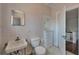 Modest bathroom features standard fixtures and a medicine cabinet, complemented by classic tiled walls at 5603 Palmetto Rd, New Port Richey, FL 34652