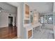Bright bathroom features white tile floors, cabinets and vanity, with warm tone accent lighting at 5603 Palmetto Rd, New Port Richey, FL 34652