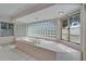 Spa-like bathroom featuring a large soaking tub surrounded by glass blocks at 5603 Palmetto Rd, New Port Richey, FL 34652