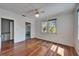 Light-filled bedroom with hardwood floors and multiple windows at 5603 Palmetto Rd, New Port Richey, FL 34652