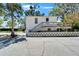 Side exterior shows the stairs to the deck and an expansive driveway with plenty of parking at 5603 Palmetto Rd, New Port Richey, FL 34652