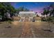 Beautiful two-story home featuring wraparound porch and brick pathway at twilight at 5603 Palmetto Rd, New Port Richey, FL 34652