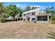 Charming two-story home with wraparound porch, lush trees, and expansive yard at 5603 Palmetto Rd, New Port Richey, FL 34652