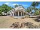 Charming two-story home with wraparound porch, lush trees, and expansive yard at 5603 Palmetto Rd, New Port Richey, FL 34652