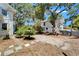 Charming outdoor space with brick driveway, lush palms, and a secondary structure at 5603 Palmetto Rd, New Port Richey, FL 34652