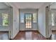 Inviting foyer with hardwood floors and natural light from a glass paneled door at 5603 Palmetto Rd, New Port Richey, FL 34652