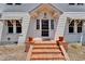 Welcoming front entrance with classic brick steps and potted plants at door at 5603 Palmetto Rd, New Port Richey, FL 34652