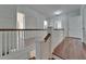 Upstairs hallway with original wood floors and white trim at 5603 Palmetto Rd, New Port Richey, FL 34652