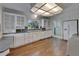 Bright kitchen with white cabinets, granite countertops, and wood floors at 5603 Palmetto Rd, New Port Richey, FL 34652