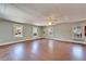 Spacious living room filled with natural light from multiple windows, featuring hardwood floors at 5603 Palmetto Rd, New Port Richey, FL 34652
