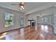 Bright living room featuring hardwood floors, a fireplace, and natural light at 5603 Palmetto Rd, New Port Richey, FL 34652