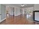 Bright living room with hardwood floors, ceiling fan, and traditional fireplace at 5603 Palmetto Rd, New Port Richey, FL 34652