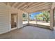 Bright, screened porch offers peaceful views of the lush backyard and a ceiling fan for comfort at 5603 Palmetto Rd, New Port Richey, FL 34652