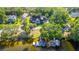 Expansive waterfront property with private dock, boat lifts, lush trees, and a charming two-story home at 5610 N River Shore Dr, Tampa, FL 33603