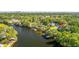 Scenic aerial view of a waterfront property nestled among lush trees with private docks and waterway access at 5610 N River Shore Dr, Tampa, FL 33603