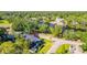 Aerial view of the property and neighborhood, showcasing proximity to water and lush landscape at 5610 N River Shore Dr, Tampa, FL 33603