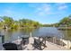 Backyard with a dock, chairs and views of the water at 5610 N River Shore Dr, Tampa, FL 33603