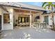 Backyard deck with a dining area, outdoor kitchen, lush trees, and metal roof at 5610 N River Shore Dr, Tampa, FL 33603