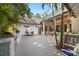 Beautiful backyard with an outdoor kitchen, BBQ, patio, lush landscaping, and a metal roof at 5610 N River Shore Dr, Tampa, FL 33603